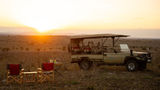 A safari vehicle explores the Serengeti wilderness near Wild Wakati Camp, offering guests front-row access to Tanzania’s iconic wildlife.