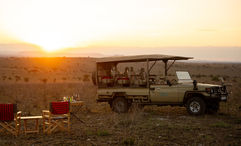 A safari vehicle explores the Serengeti wilderness near Wild Wakati Camp, offering guests front-row access to Tanzania’s iconic wildlife.