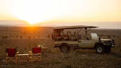 A safari vehicle explores the Serengeti wilderness near Wild Wakati Camp, offering guests front-row access to Tanzania’s iconic wildlife.
