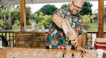 A bartender prepares a round of mai tais for guests taking the Kauai Rum Safari Tour at Kilohana Plantation.