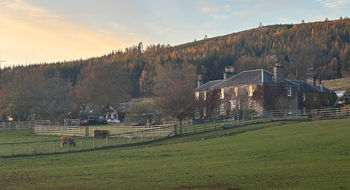 The sun sets over The Old Manse of Blair, a boutique hotel in the Scottish Highlands.